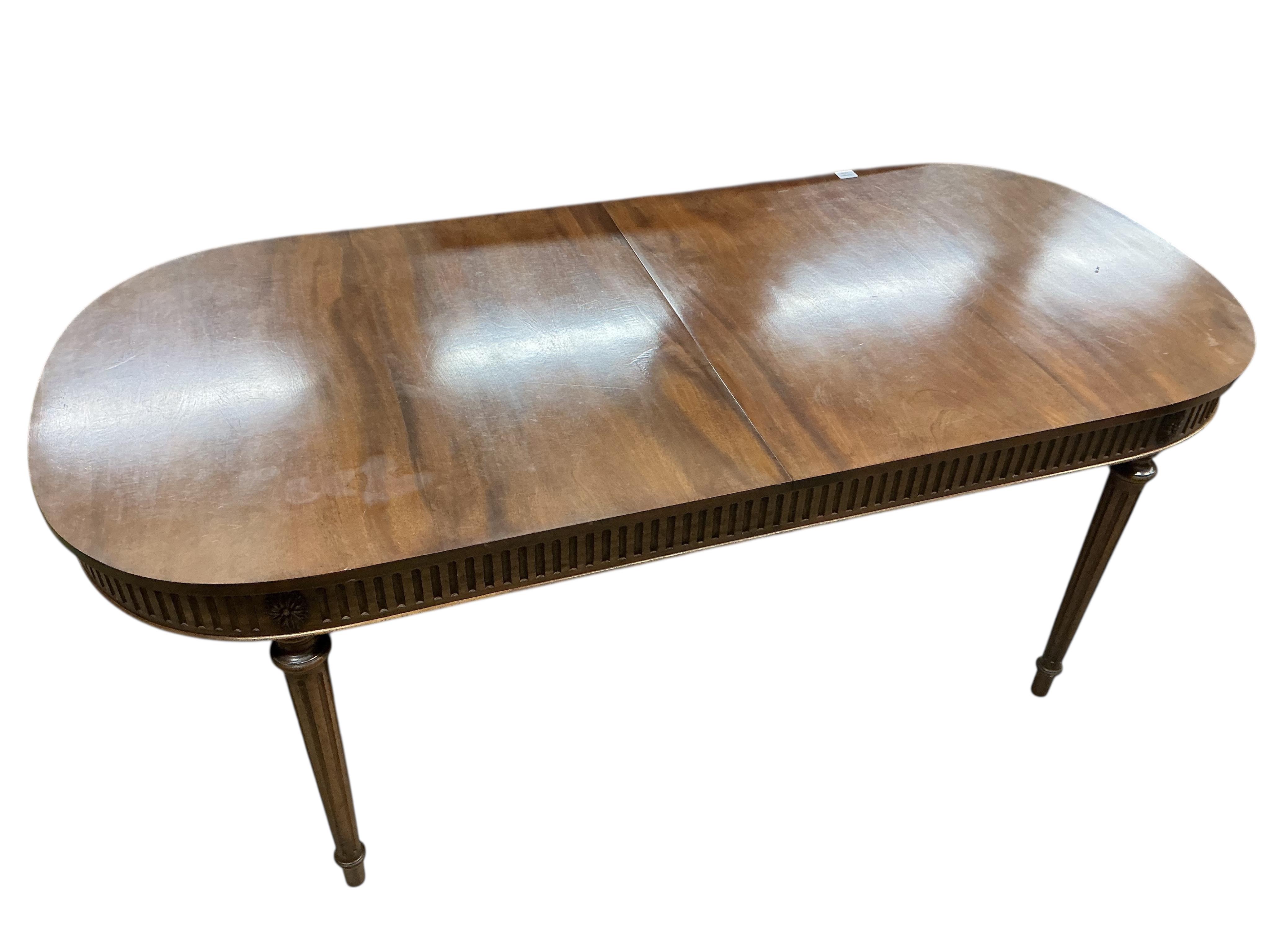 A reproduction Sheraton style mahogany extending dining table, 260cm extended, one spare leaf, width 91cm, height 76cm